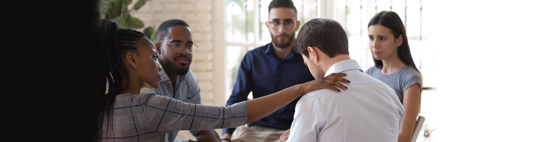 female employee putting hand on coworkers shoulder