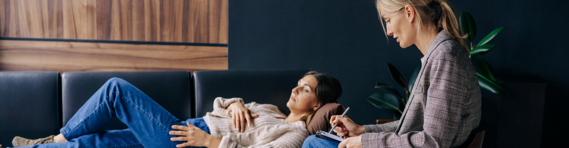 patient talking to her doctor while lying in sofa